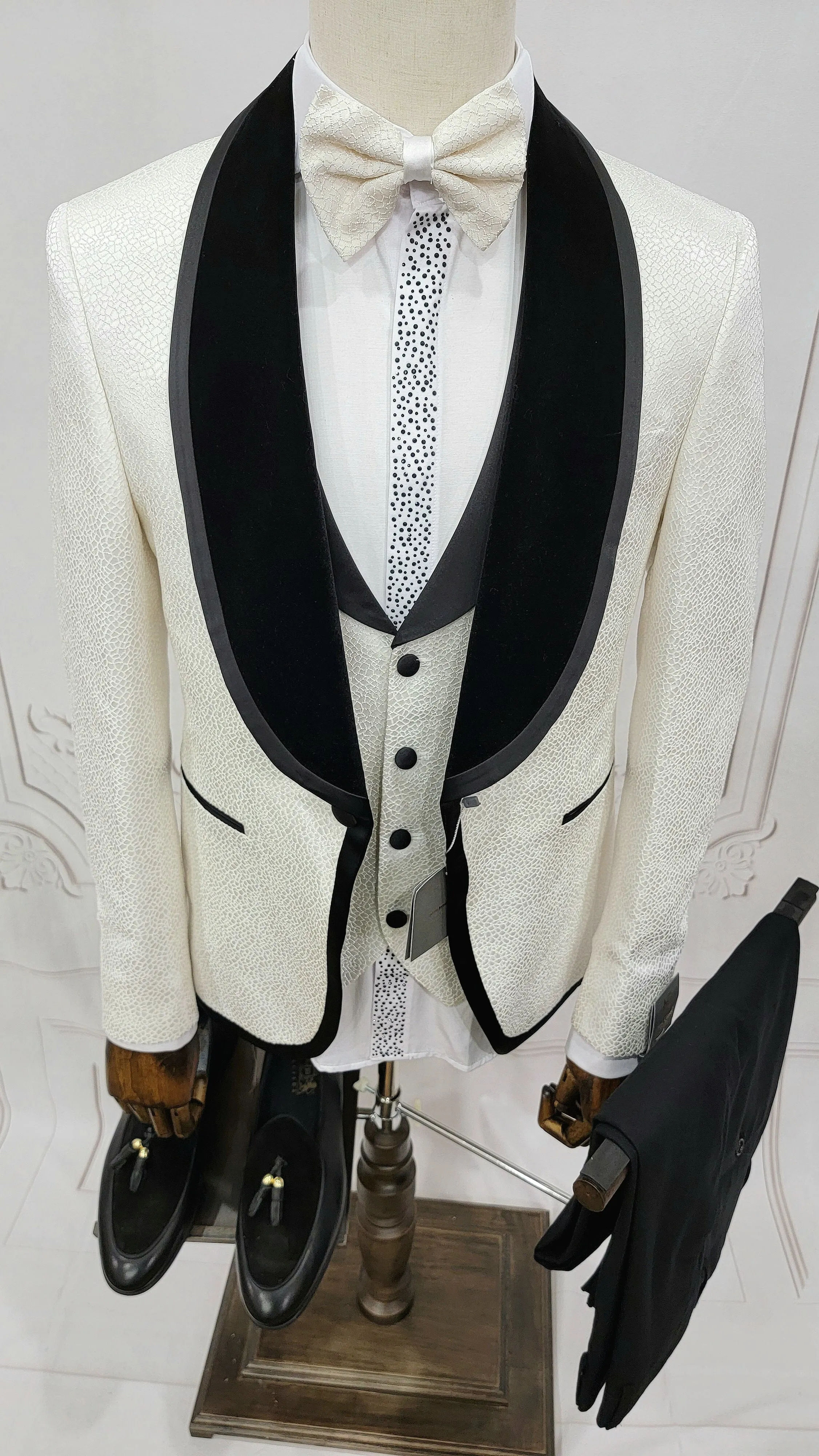 Three Pieces Tuxedo Suit with contrasting black velvet Lapel, matching bow tie and Black Pants.