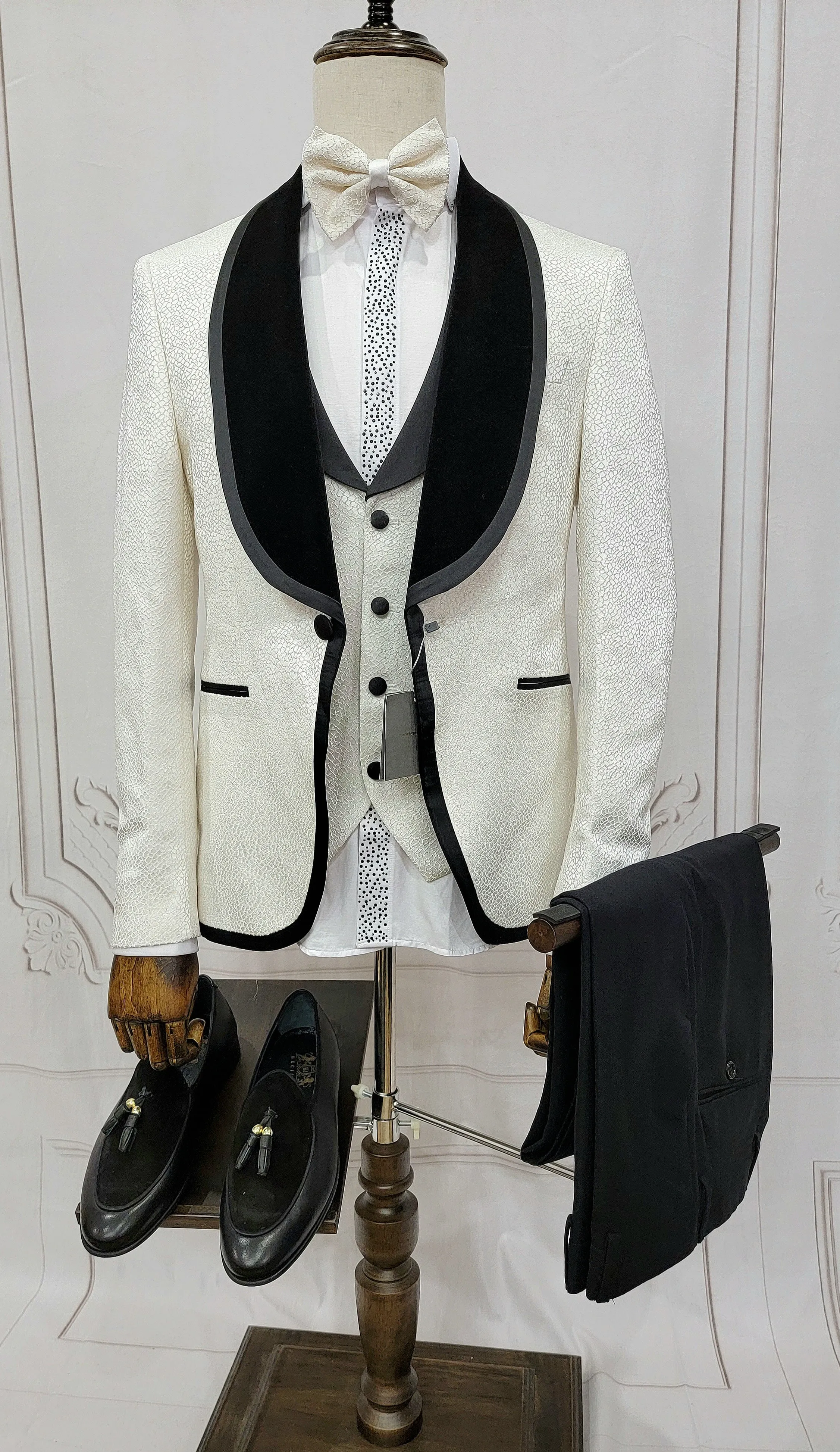 Three Pieces Tuxedo Suit with contrasting black velvet Lapel, matching bow tie and Black Pants.