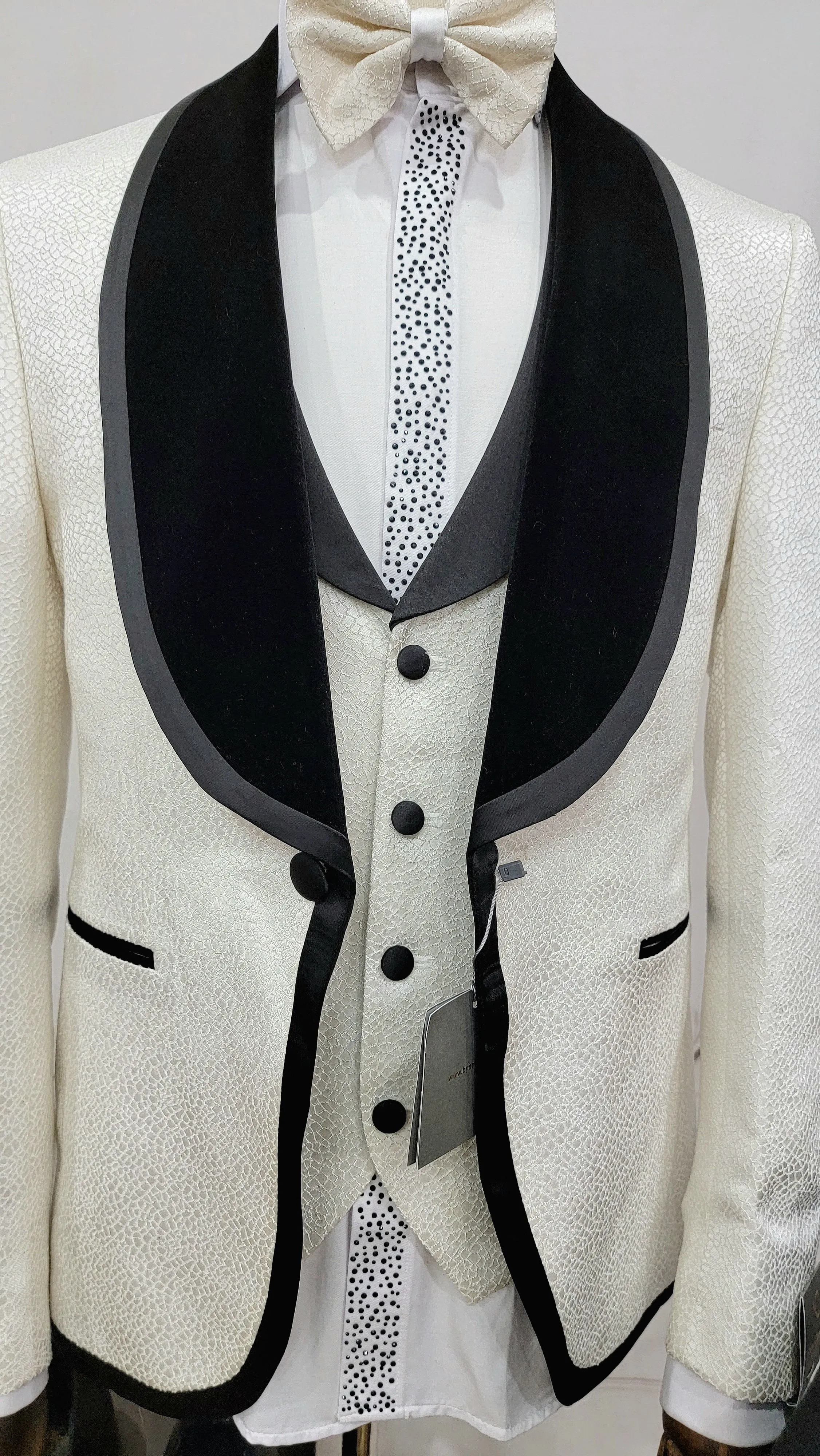 Three Pieces Tuxedo Suit with contrasting black velvet Lapel, matching bow tie and Black Pants.