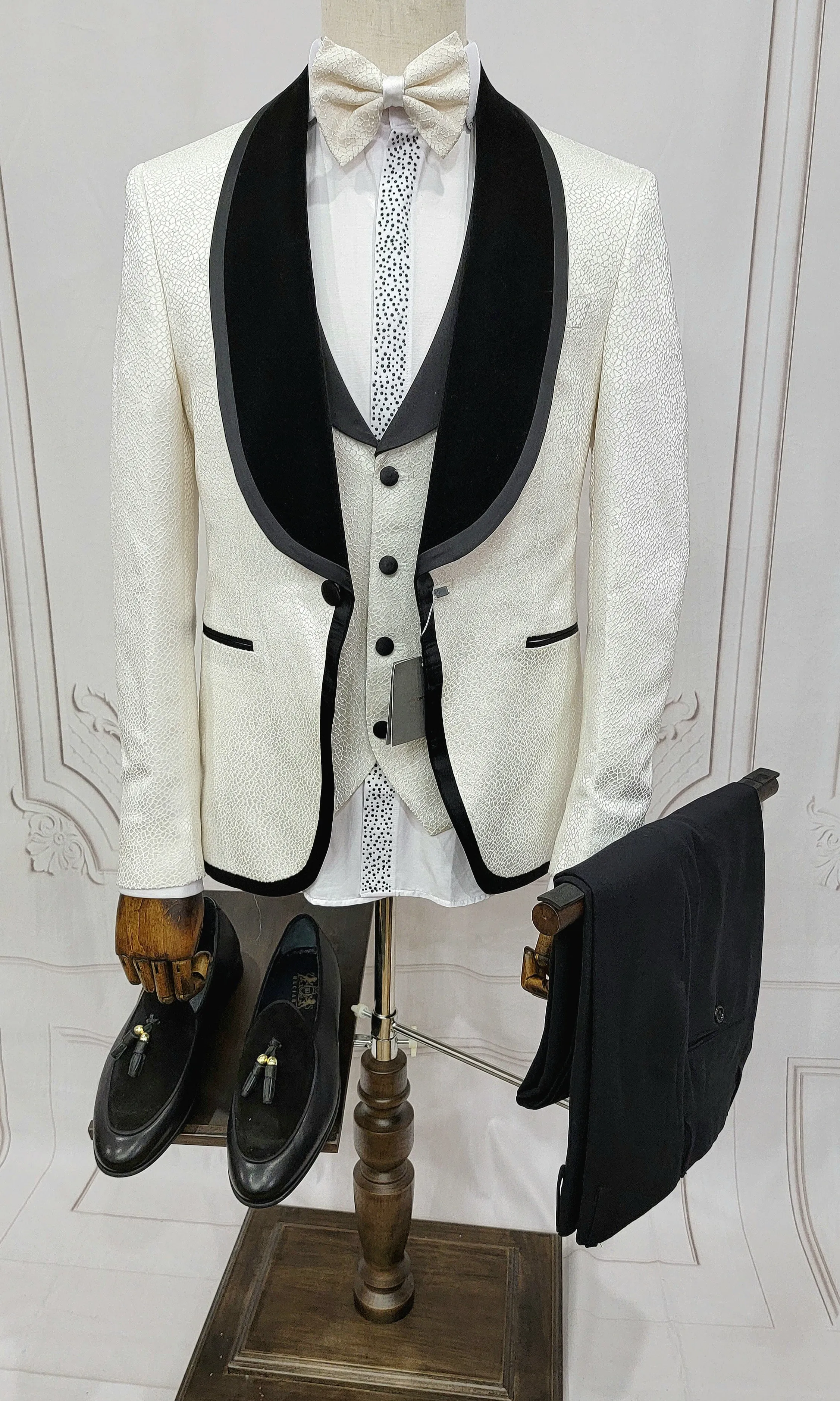 Three Pieces Tuxedo Suit with contrasting black velvet Lapel, matching bow tie and Black Pants.