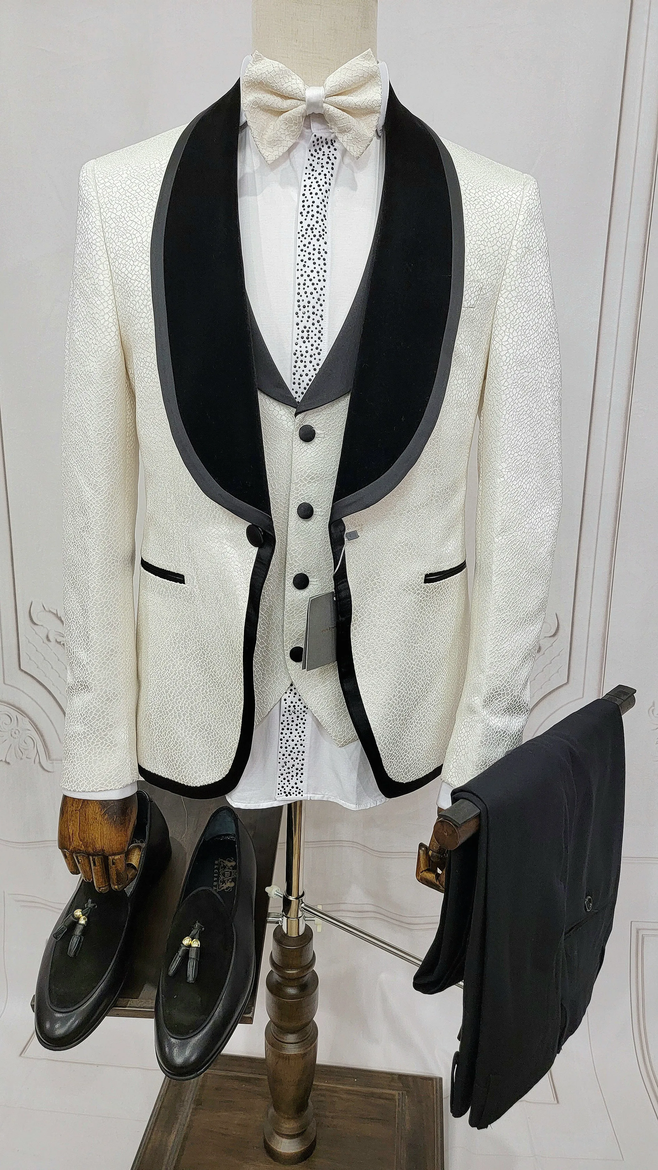 Three Pieces Tuxedo Suit with contrasting black velvet Lapel, matching bow tie and Black Pants.