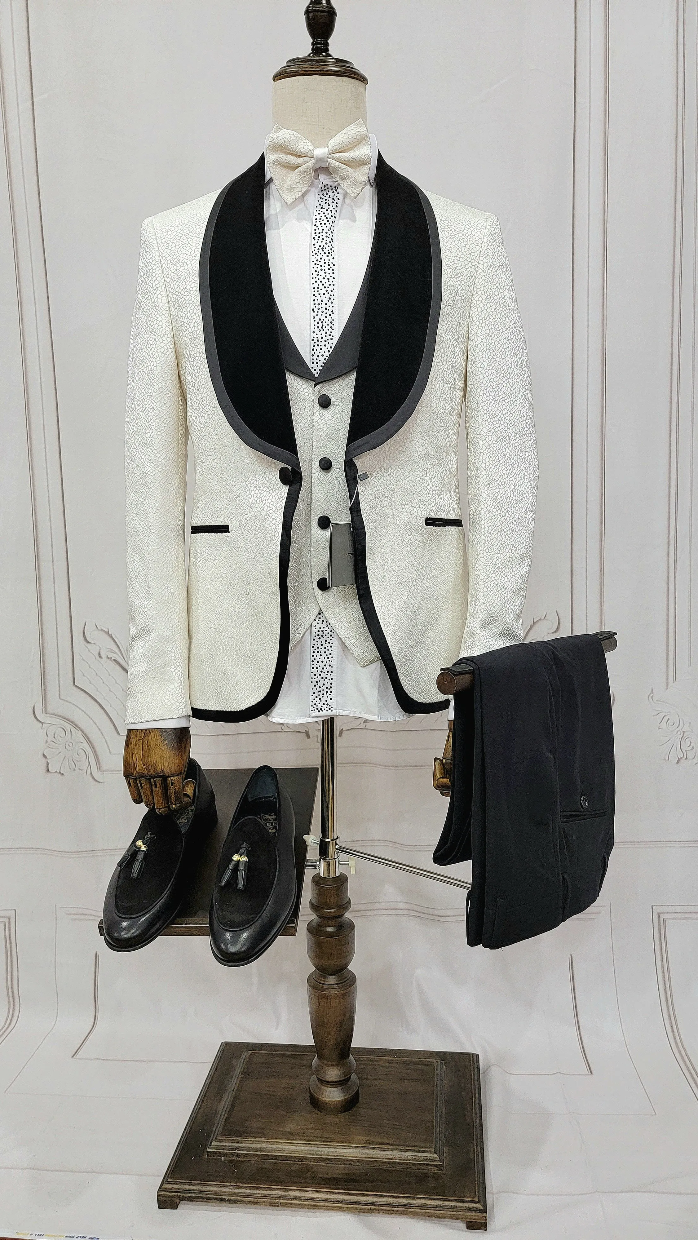 Three Pieces Tuxedo Suit with contrasting black velvet Lapel, matching bow tie and Black Pants.