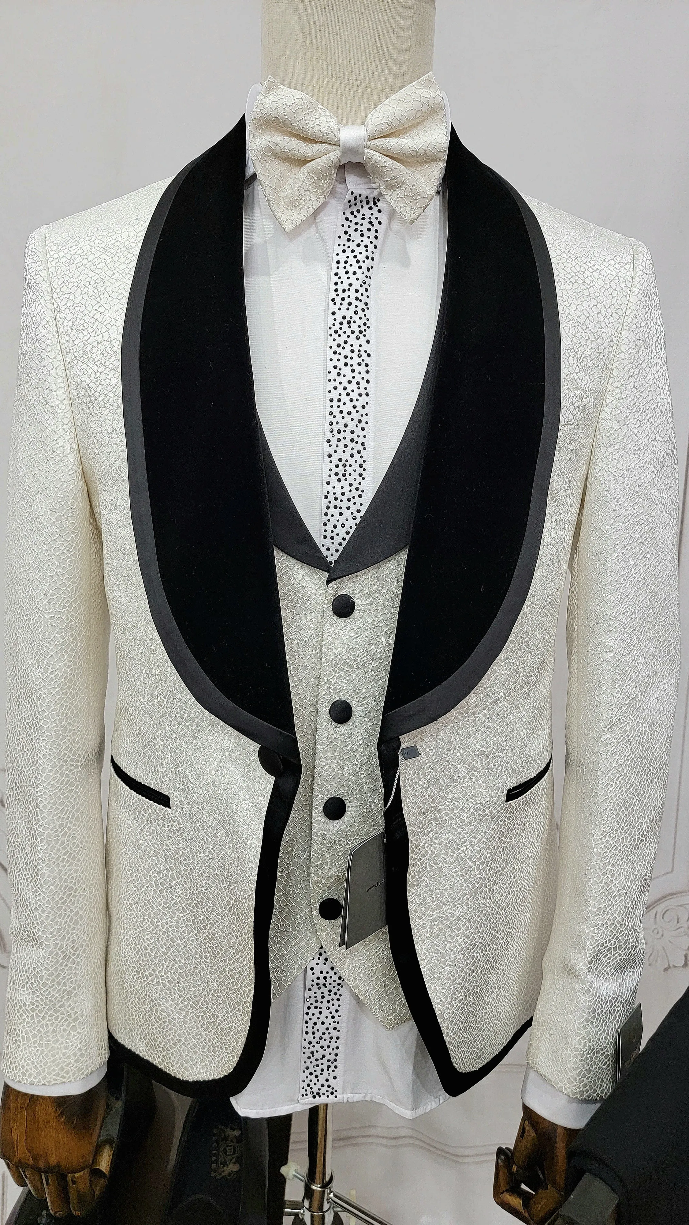 Three Pieces Tuxedo Suit with contrasting black velvet Lapel, matching bow tie and Black Pants.