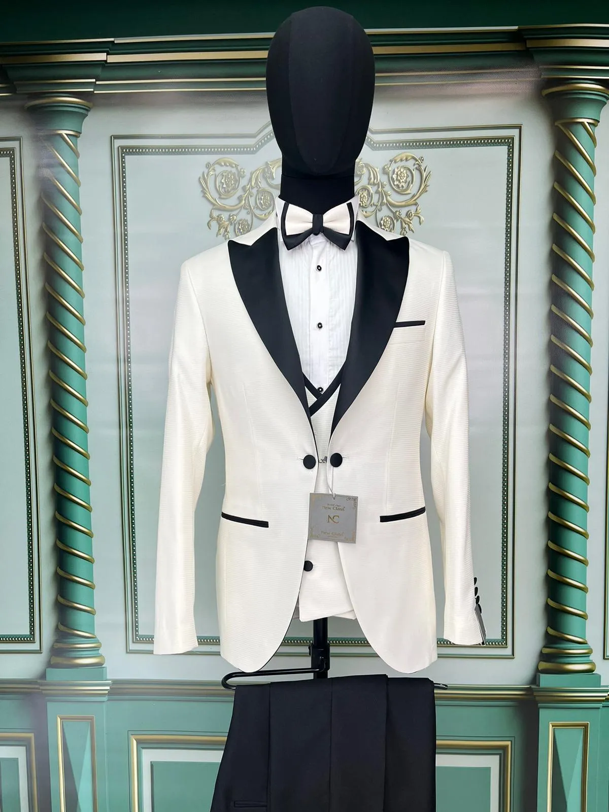 Three Pieces Tuxedo Suit with contrasting black velvet Lapel, matching bow tie and Black Pants.