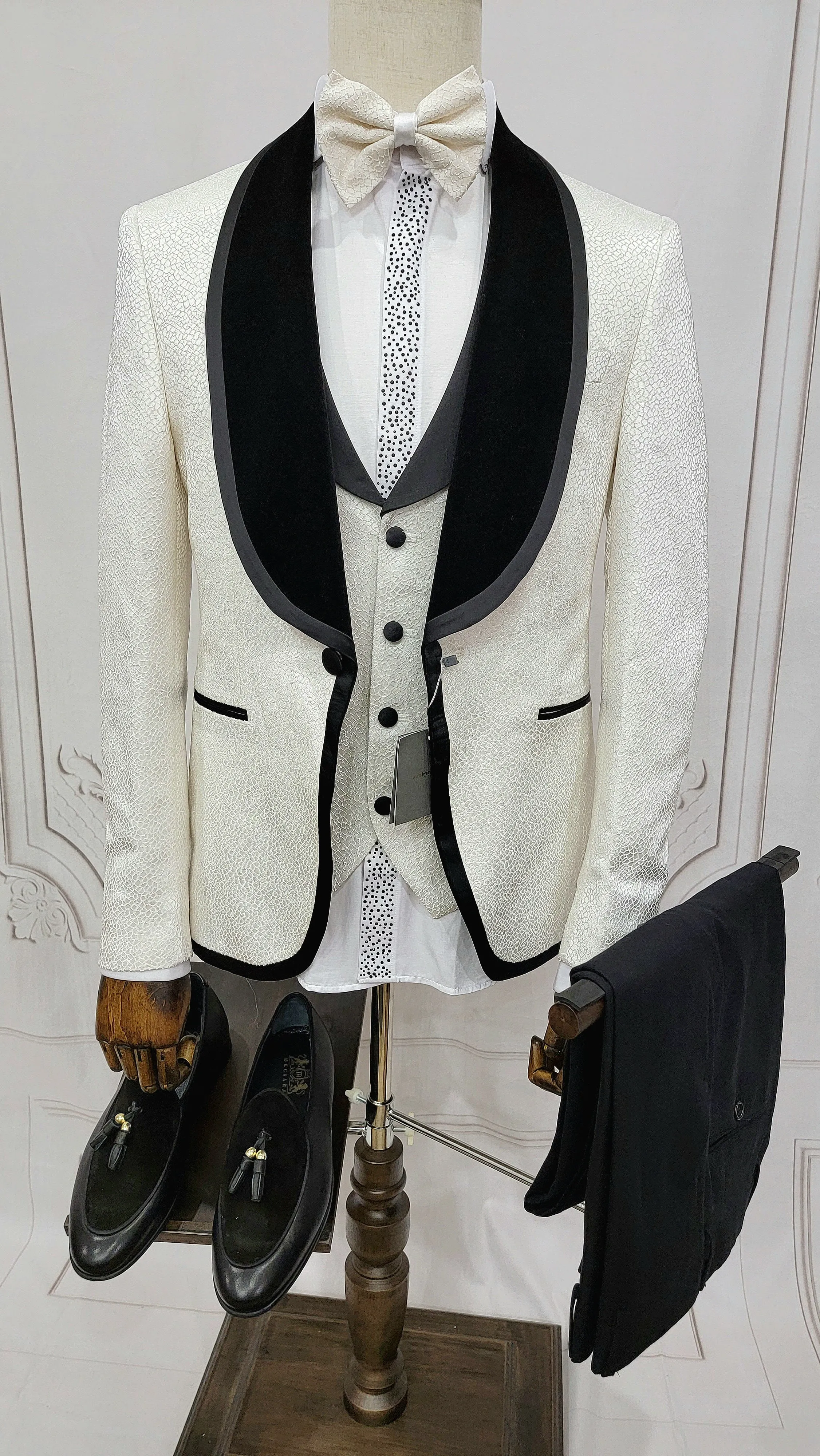 Three Pieces Tuxedo Suit with contrasting black velvet Lapel, matching bow tie and Black Pants.